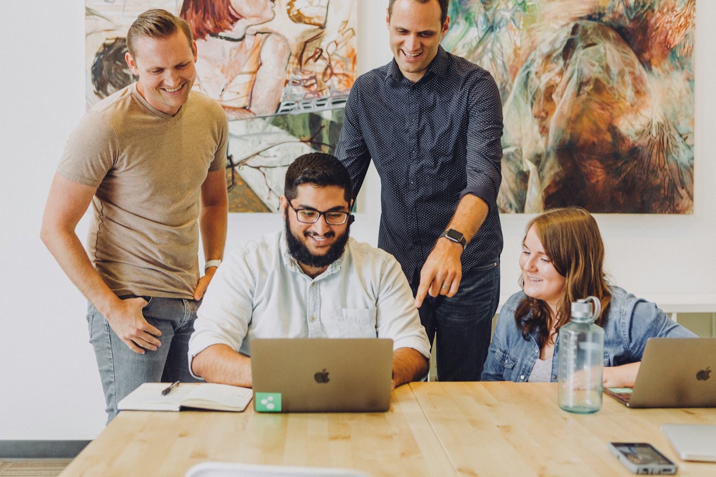 A startup team working together around a laptop